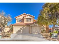 Charming two-story home with a well-manicured front yard and a spacious three-car garage at 7848 Desert Bell Ave, Las Vegas, NV 89128