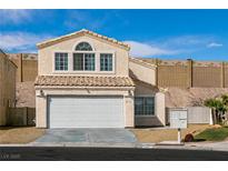 Two-story home featuring a two-car garage, charming windows, and a well-kept front yard with a tidy mailbox area at 2115 Saint Paul Way, Las Vegas, NV 89104