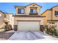 Two-story home featuring a two-car garage, neutral colors, and desert landscaping at 2865 Vigilante Ct, North Las Vegas, NV 89081