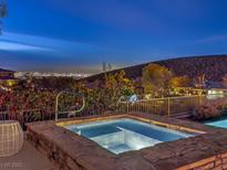 Inviting hot tub with scenic city views provides a tranquil escape at 30 Dry Brook Trl, Henderson, NV 89052