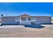 Charming single-story home featuring a covered front porch and neutral exterior paint at 3581 W Dyer Rd, Pahrump, NV 89048