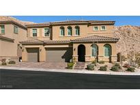 Stunning two-story house showcasing its elegant architecture and well-manicured front yard at 3830 Montone Ave, Las Vegas, NV 89141