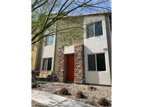 Charming two-story home featuring a stone accented entryway and covered front porch at 4381 Fire Glow Ave, North Las Vegas, NV 89084