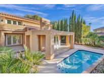 Stunning backyard pool featuring a covered patio and lush landscaping, perfect for outdoor relaxation and entertainment at 4961 Tierra Del Sol Dr, Las Vegas, NV 89113