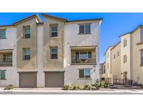 Charming townhouse featuring a private balcony, two-car garage, and neutral color palette at 6952 Midnight Bronze St, North Las Vegas, NV 89086