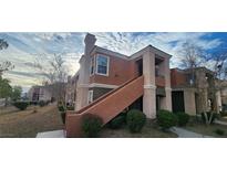 Charming two-story condo featuring neutral-colored stucco, a private balcony, and well-maintained landscaping at 7700 Constanso Ave # 204, Las Vegas, NV 89128