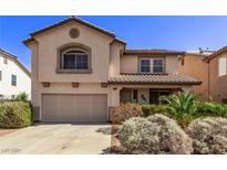 Two-story home features an attached two-car garage and well-maintained landscaping at 774 Wigan Pier Dr, Henderson, NV 89002