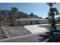 Inviting single-story home showcasing desert landscaping, a spacious driveway, and an attached three-car garage at 1108 Sidehill Way, Las Vegas, NV 89110