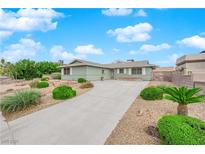 Charming single-story home featuring a well-manicured lawn and a long private driveway at 2058 Citroen St, Las Vegas, NV 89142