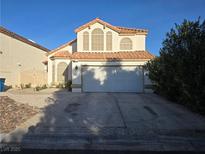 Charming two-story home featuring a terracotta roof, arched windows, and a two-car garage at 3550 Leor Ct, Las Vegas, NV 89121