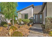 Beautiful home featuring a well-maintained front yard with desert landscaping and a charming walkway leading to the front door at 4775 E Beacon Ridge Dr, Pahrump, NV 89061