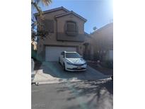 Two-story home with a driveway and two-car garage in a residential neighborhood at 4970 Copperlyn St, Las Vegas, NV 89122