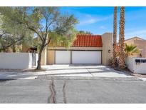 Charming two-story home featuring a two-car garage, red-tiled roof, and desert landscaping at 5102 Tennis Ct, Las Vegas, NV 89120