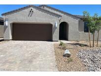 Charming single-story home with a two-car garage and low maintenance desert landscaping at 5980 E Drosetta Ave, Pahrump, NV 89061