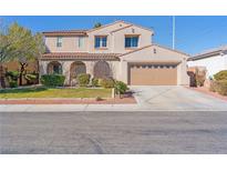 Charming two-story home featuring a red tile roof, attached garage, and well-manicured lawn at 6337 Black Mane Way, North Las Vegas, NV 89081