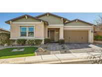 Charming home featuring a manicured lawn, complemented by rock landscaping and a welcoming two-car garage at 668 Look Lively Ct, Henderson, NV 89011