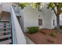 Attractive condo building with stairs and landscaping creates a welcoming curb appeal at 7100 Pirates Cove Rd # 2067, Las Vegas, NV 89145