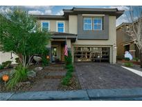 Beautiful two-story home featuring a brick driveway, stone steps, and modern design at 10605 Harvest Green Way, Las Vegas, NV 89135