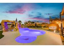 Backyard pool with a grotto, slide, and comfortable outdoor seating at 200 E Desert Rose Dr, Henderson, NV 89015