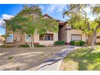 Inviting condo exterior with desert landscaping, mature trees, and a charming walkway leading to the entrance at 231 W Horizon Ridge Pkwy # 2413, Henderson, NV 89012