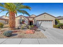 Charming single-story home featuring a desert landscape, mature palm tree, and a two-car garage at 2520 Eclipsing Stars Dr, Henderson, NV 89044