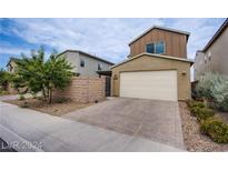 Charming two-story home features a neutral color palette, a two-car garage, and landscaped front yard at 3066 Casarano Ct, Henderson, NV 89044