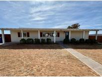 Charming single-story home with a well-maintained front yard and covered entrance at 325 Ron Ave, Logandale, NV 89021