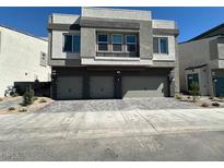 Modern two-story home featuring a three-car garage and contemporary architectural details at 4238 Lemay St # 2, Las Vegas, NV 89115