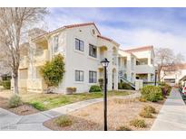 Inviting condo featuring a red tile roof and well-maintained landscaping at 4877 S Torrey Pines Dr # 202, Las Vegas, NV 89103