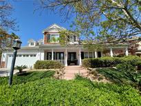 Charming two-story home with beautiful landscaped front yard and welcoming front porch at 7220 Shenandoah Springs Ave, Las Vegas, NV 89131