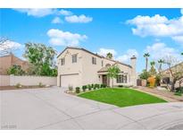 Inviting two-story home with lush front lawn, desert landscaping, and a two car garage at 8324 Shark Tank Ct, Las Vegas, NV 89128