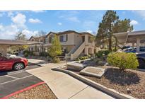 Inviting two-story condo with well-maintained landscaping, covered parking, and convenient access at 10225 King Henry Ave # 102, Las Vegas, NV 89144