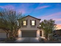 Charming two-story home with a well-manicured front yard and a two-car garage at 10655 Tray Mountain Ave, Las Vegas, NV 89166