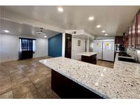 Open kitchen featuring spacious island with granite countertops and stainless-steel appliances at 2324 E Oakey Blvd, Las Vegas, NV 89104