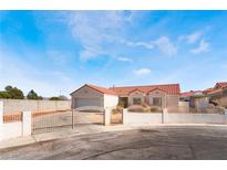 Charming single-story home featuring a red tile roof and gated front yard at 4142 Forestville St, North Las Vegas, NV 89032