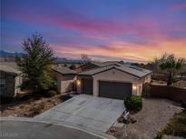 Charming home with a two-car garage and inviting curb appeal set against a beautiful sunset sky at 4755 S Santa Fiora St, Pahrump, NV 89061