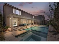 Beautiful backyard pool and patio area, perfect for outdoor entertaining with covered seating at 9781 Arcadian Estate Ct, Las Vegas, NV 89141