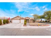 Charming single-story home featuring a well-manicured front yard and a two-car garage at 4318 Red Blanket Rd, North Las Vegas, NV 89032