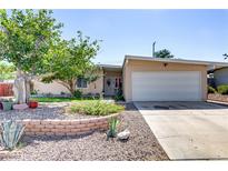 Charming single-story home featuring a well-manicured front yard and an attached two-car garage at 5109 Sugarfoot Ave, Las Vegas, NV 89107