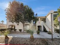Charming two-story condo with desert landscaping and stucco exterior offers a welcoming entrance at 6701 Squaw Mountain Dr # 201, Las Vegas, NV 89130