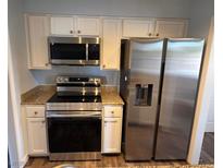 Modern kitchen features stainless steel appliances, granite countertops, and ample storage space at 753 Oakmont Ave # 802, Las Vegas, NV 89109
