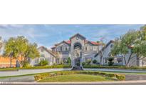 Stunning two-story home with a beautifully landscaped front yard and a symmetrical, elegant facade at 8625 Scarsdale Dr, Las Vegas, NV 89117