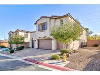Two-story home featuring a two-car garage, desert landscaping, and neutral paint scheme at 9085 Bridal Creek Ave, Las Vegas, NV 89178