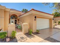 Charming single-story home featuring a well-manicured lawn, tile roof, and attached two-car garage at 9545 Eagle Valley Dr, Las Vegas, NV 89134