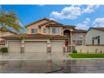 Stunning two-story home featuring a three-car garage and meticulously maintained landscaping at 10626 San Vercelli Ct, Las Vegas, NV 89141