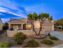 Beautiful single-story home features desert landscaping and a two-car garage, enhancing its curb appeal at 2219 Sawtooth Mountain Dr, Henderson, NV 89044