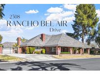 Charming single-story brick home featuring a spacious driveway, well-kept landscaping, and inviting covered porch at 2508 Rancho Bel Air Dr, Las Vegas, NV 89107