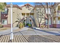 Attractive two-story condo featuring well maintained landscaping and inviting walkways at 3933 Lazy Pine St # 204, Las Vegas, NV 89108
