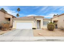 Charming single-story home featuring a well-maintained front yard and a two-car garage at 7858 Nookfield Dr, Las Vegas, NV 89147