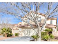 Charming two-story home with a two-car garage and mature landscaping, including palm trees at 9836 La Vid Ct, Las Vegas, NV 89117